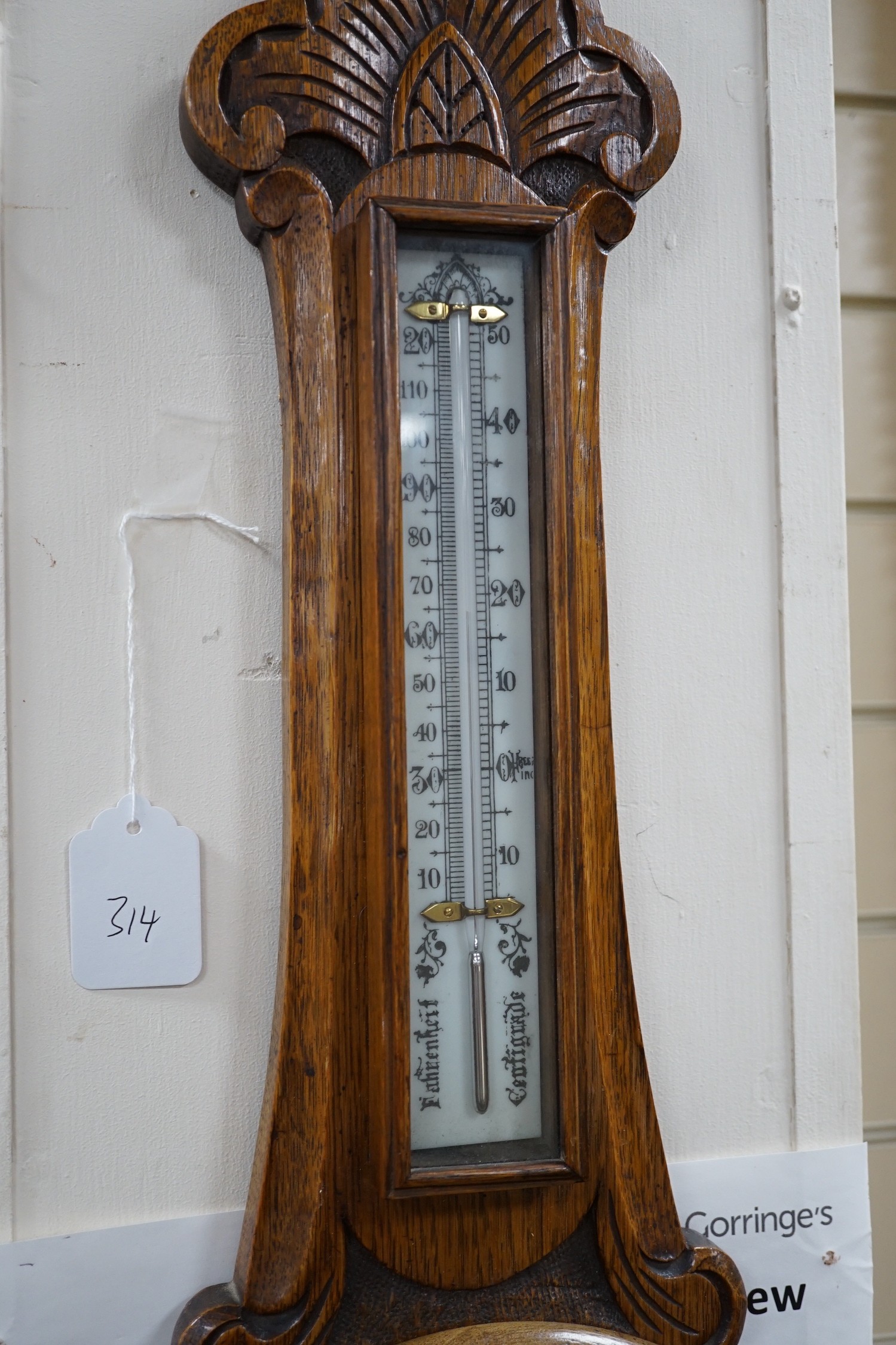 An Edwardian carved oak aneroid wheel barometer, 85cm *Please note the sale commences at 9am.